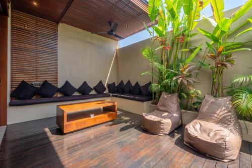 a living room with a couch and a coffee table at Nala Villa - Peaceful Hideaway with Pool & Yoga Space in Canggu