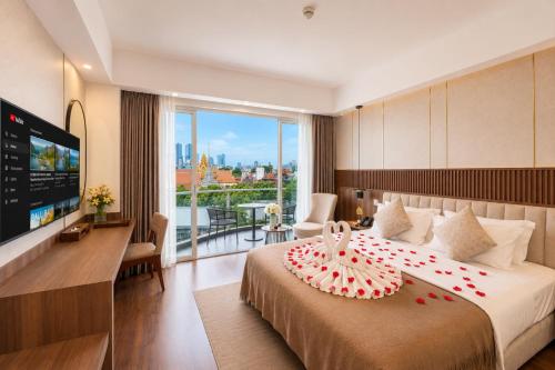 a hotel room with a bed with a cake on it at Harmony Phnom Penh Hotel in Phnom Penh
