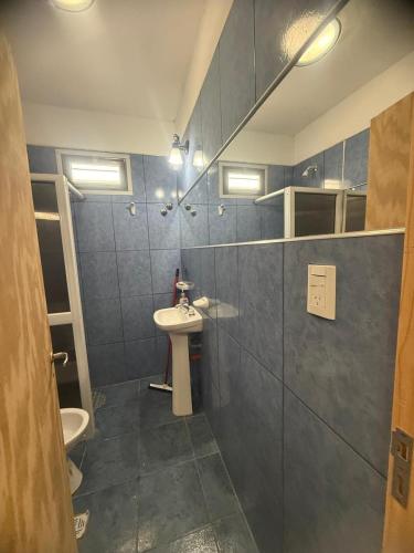 a bathroom with a sink and a toilet at Acordes de Gaitas - Departamento 1 in Malargüe