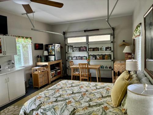 a bedroom with a bed and a table in a room at Comfort Nest in Pahoa