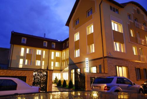 a building with cars parked in front of it at Hotel Citrin - Adults Only in Braşov