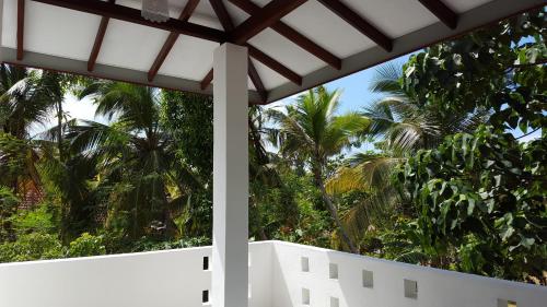 a view from the porch of a house with palm trees at Emildale Villa in Wadduwa