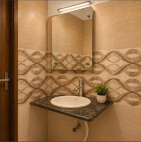 a bathroom with a sink and a mirror at Hotel Goverdhan - Walking to Raja Ki Mandi Railway and 3km from ISBT in Agra