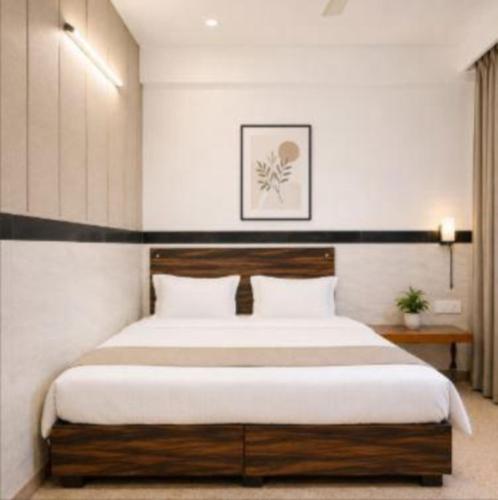a bedroom with a large bed with white sheets at Hotel Goverdhan - Walking to Raja Ki Mandi Railway and 3km from ISBT in Agra