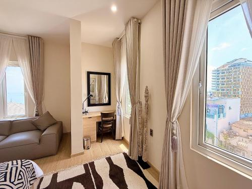 a living room with a couch and a large window at The View Boutique Hotel in Vung Tau