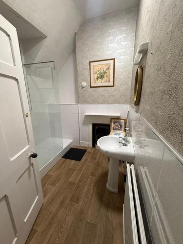 a bathroom with a sink and a fireplace at The Navigation Inn Hotel in Derby