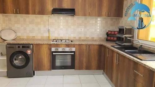 a kitchen with a stove and a dishwasher at Résidence Marina in Sousse