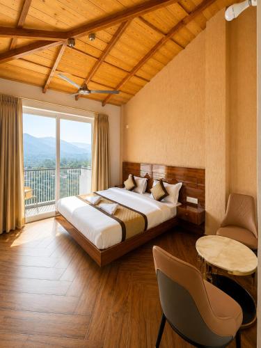 a bedroom with a bed and a large window at Ramasa Lake House in Bhīm Tāl