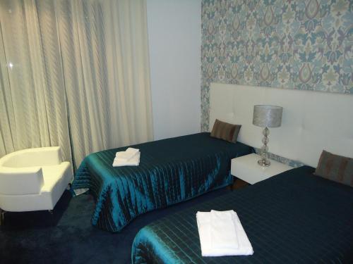 En eller flere senger på et rom på Marina Vilamoura Apartment