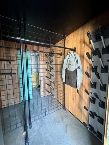 a walk in shower in a room with wine racks at Alpine Digs in Jindabyne