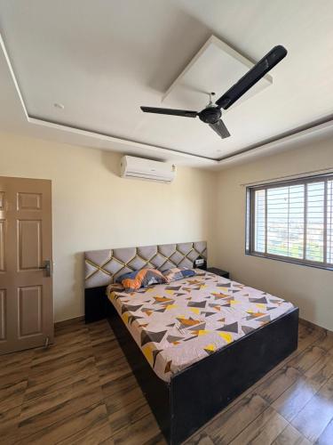 a bedroom with a bed and a ceiling fan at cloud nine in Boria Kalān