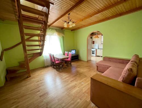a living room with a couch and a table at Passage Apartments 10a in Skhidnitsa