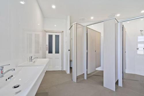 a white bathroom with two sinks and a mirror at Imperial Hotel Singleton in Singleton
