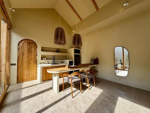a kitchen with a table and chairs in a room at 1 BR Private Pool Villa for Two - Casa Manja in Krambitan