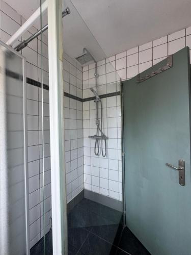 a shower with a glass door in a bathroom at L'Escapade Sélestadienne in Sélestat