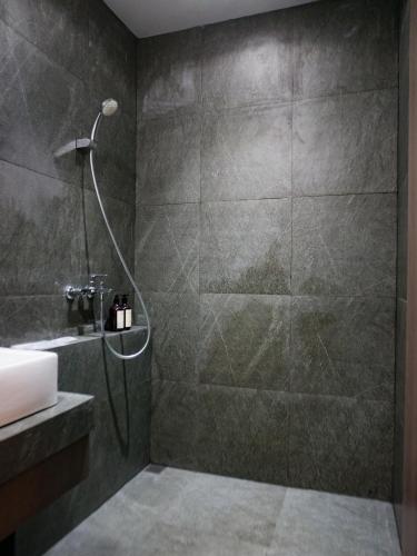 a bathroom with a shower and a sink at Singgah Ijen in Biau