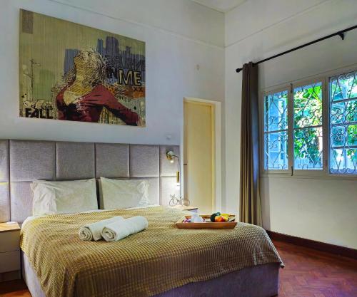 a bedroom with a bed with two towels on it at Guesthouse MALAGUETA INN II in Maputo