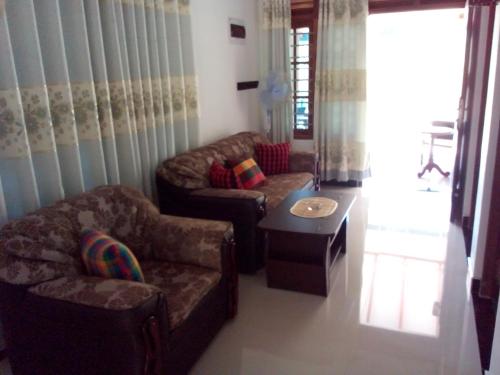 a living room with two couches and a coffee table at See Turtle Villa in Tangalle