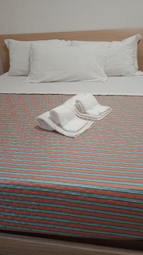 a white towel is sitting on a bed at Locri27 Apartment in Catanzaro Lido