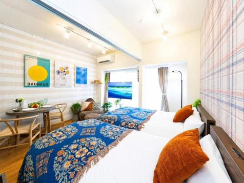 a bedroom with a bed and a dining room at 旅鴉 inn 高松 - 高松駅徒歩5分 in Takamatsu