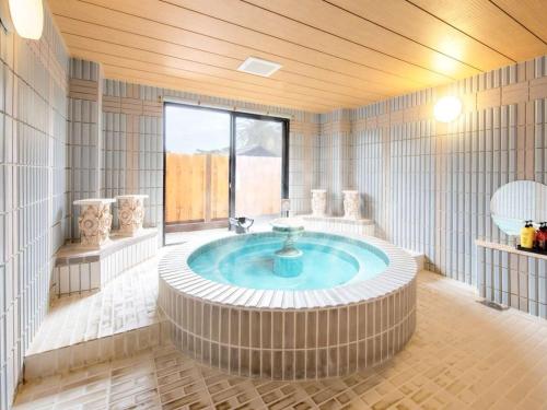 a large bathroom with a large tub in a room at Inatori Akao Hotel in Higashiizu