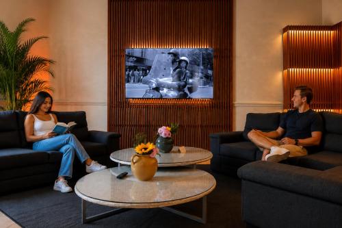 a group of people sitting in a living room at Hostal Central Oaxaca in Oaxaca City