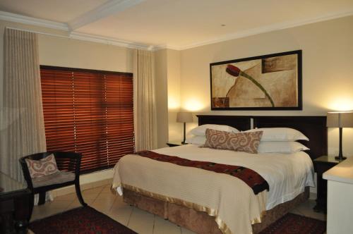 a bedroom with a large bed and a window at Rustenburg Boutique Hotel in Rustenburg