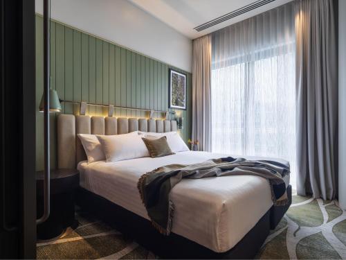 a bedroom with a large bed and a window at Adina Hobart in Hobart