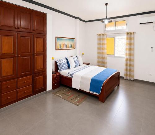 a bedroom with a bed and a dresser in it at KFC Homes in Yaoundé