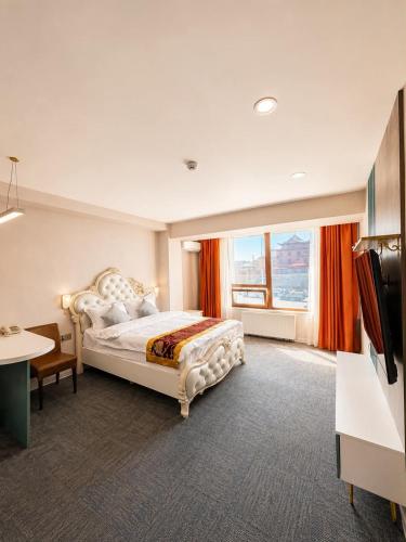 a bedroom with a bed and a large window at Margad Hotel in Ulaanbaatar