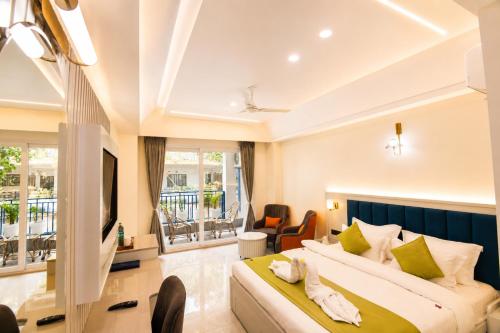 a hotel room with two beds and a television at Arista Haven Hotel in Rishīkesh