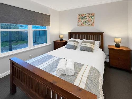 a bedroom with a large bed and a window at Gables on Malcolm in Mansfield