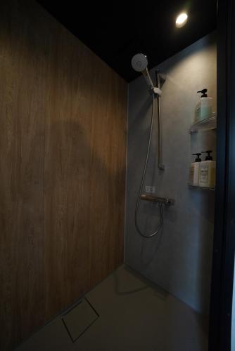 a bathroom with a shower with a shower head at 紀の川みんと静 in Kinokawa