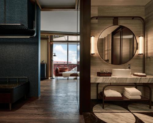 a bathroom with a sink and a mirror at Thompson Shanghai Expo, by Hyatt in Shanghai