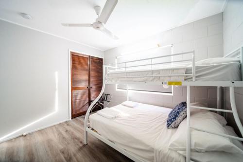a bedroom with a bunk bed in a white room at Comfy Kirwan Getaway in Ross River