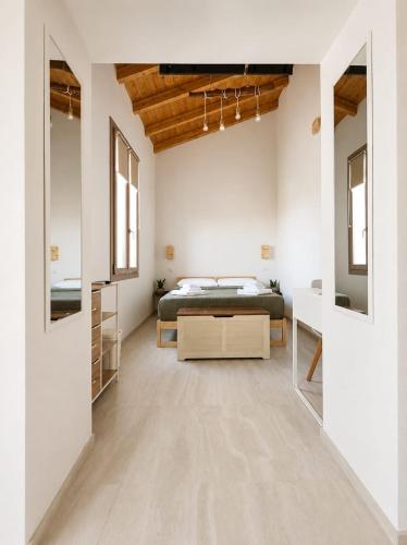 a bedroom with white walls and a bed and a mirror at Marconi 306 in Quartu Sant'Elena