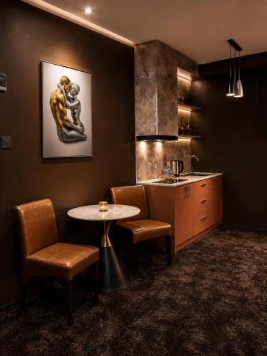 a kitchen with a table and some chairs and a counter at Margad Hotel in Ulaanbaatar