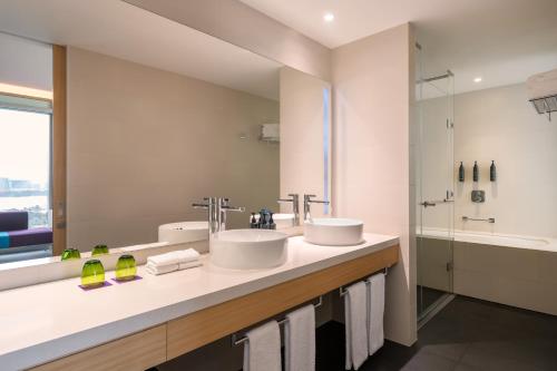 a bathroom with two sinks and a shower at Aloft by Marriott Dubai Creek in Dubai