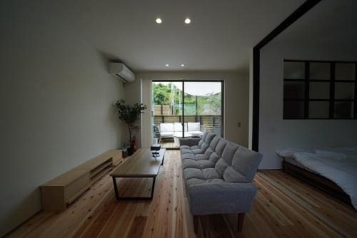 a living room with a couch and a table at 紀の川みんと間 in Kinokawa
