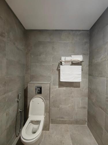 un bagno con WC e asciugamani di HUAZHU LUYI Service Apartment 华住庐艺 a Riyad