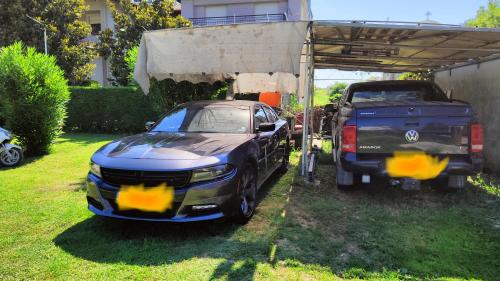 a car parked under a shed next to a truck at Nakis Apartment All Seasons in Stavros