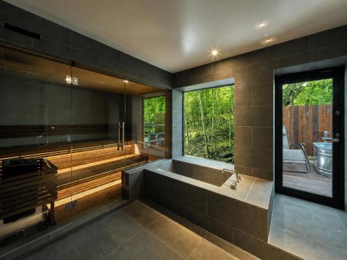 a large bathroom with a tub and a window at N3 ATAMI-Forest- in Atami