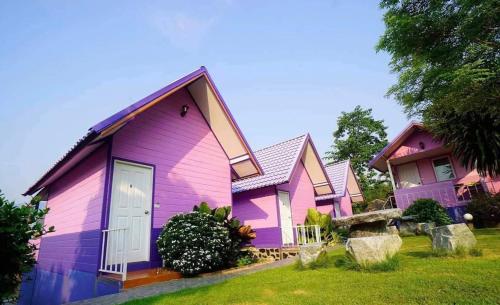 a group of purple homes in a yard at แพ ณ จันทร์ in Sathani Nam Tok