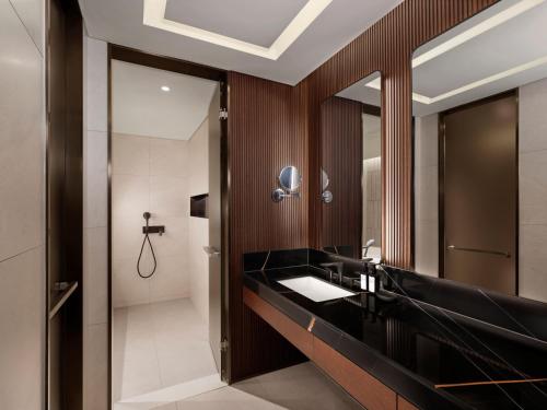 a bathroom with a black sink and a mirror at Wyndham Goseong Gangwon Hotel in Goseong