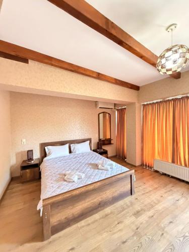 a bedroom with a large bed in a room at Hotel Traveler in Kutaisi