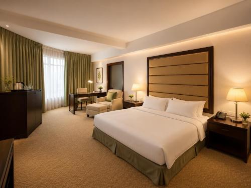 a hotel room with a large bed and a desk at Oriental Crystal Hotel in Kajang