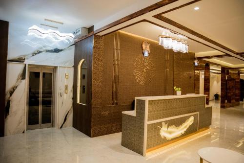 a lobby with a reception desk in a building at Raphilhin The Business Hotel in Perintalmanna