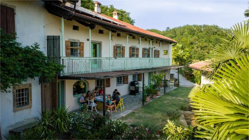 a group of people sitting outside of a building at Dorče Authentic Country House in Kojsko