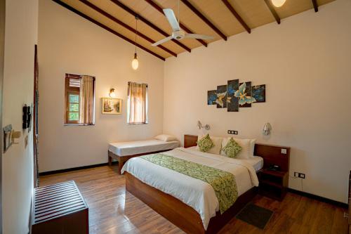 a bedroom with a bed and a desk in it at Gloria Grand Hotel in Unawatuna