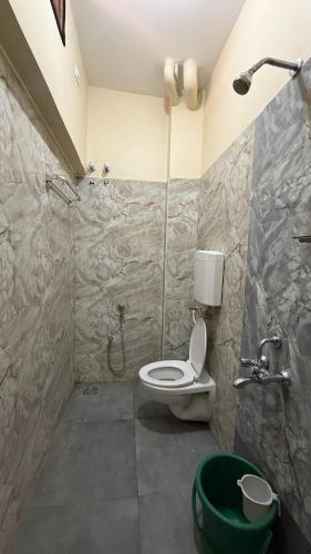 a bathroom with a toilet and a shower at Gravity Groups Core - Sakthi residency in Puducherry Airpoert